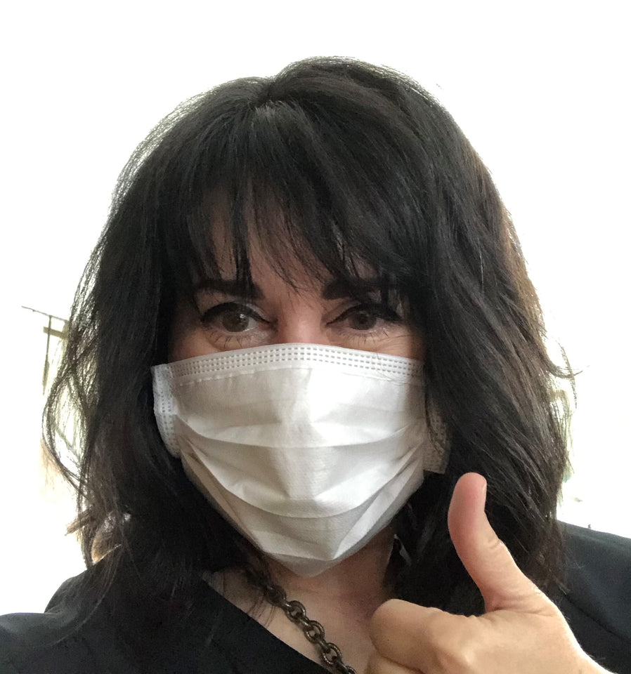 Image of Colleen Abrie wearing a Luosh American Made face masks.  She is giving the mask a thumb's up to signal satisfaction with her purchase of the high quality masks. She comments "If you gotta wear one, wear Luosh USA made."